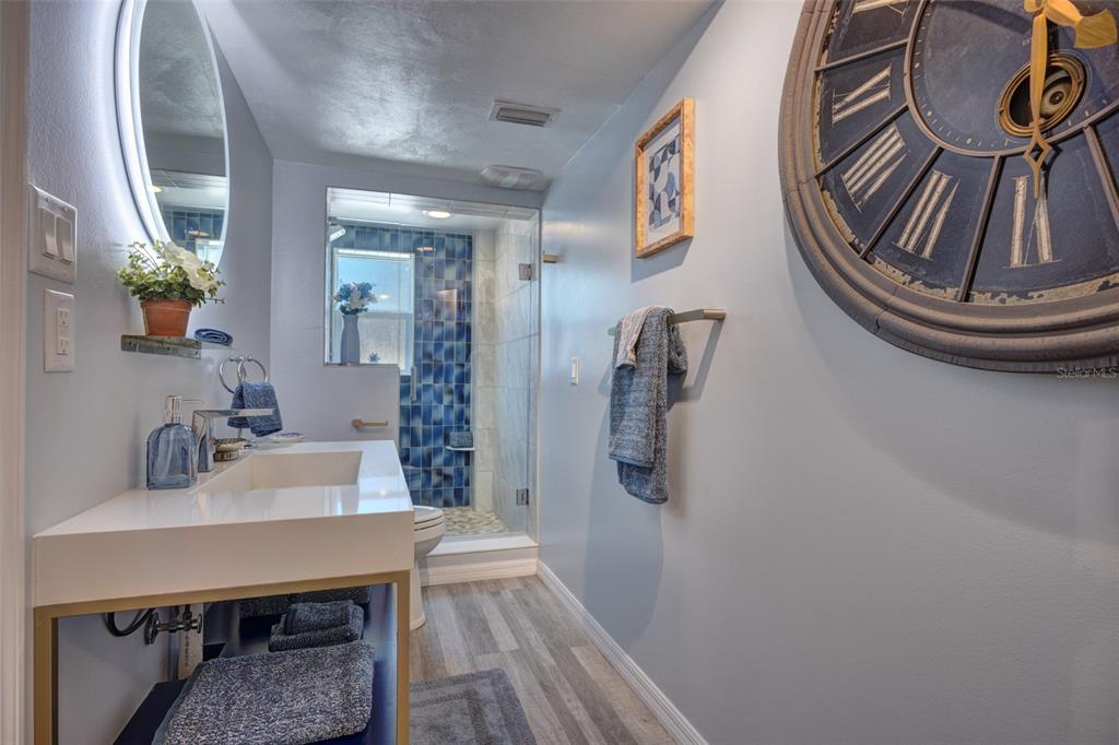 105 Riverside Drive Ormond Beach, FL 32176 - Photo 74 of 100 a bathroom with a sink a mirror and wooden floor