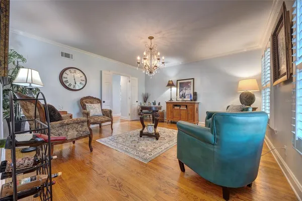 a kitchen with stainless steel appliances granite countertop a table chairs sink and cabinets