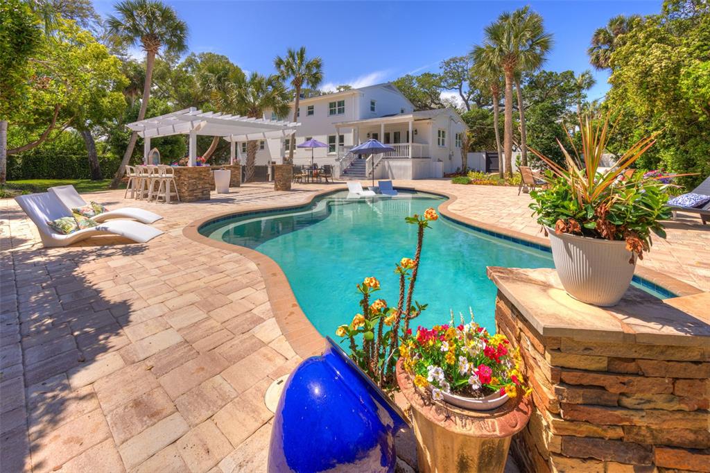 105 Riverside Drive Ormond Beach, FL 32176 - Photo 93 of 100 a view of a patio with table and chairs potted plants