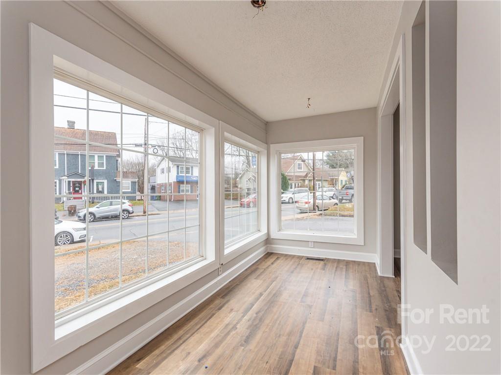 841 Haywood Road Asheville, NC 28806 - Photo 12 of 31 a view of a room with wooden floor and a window
