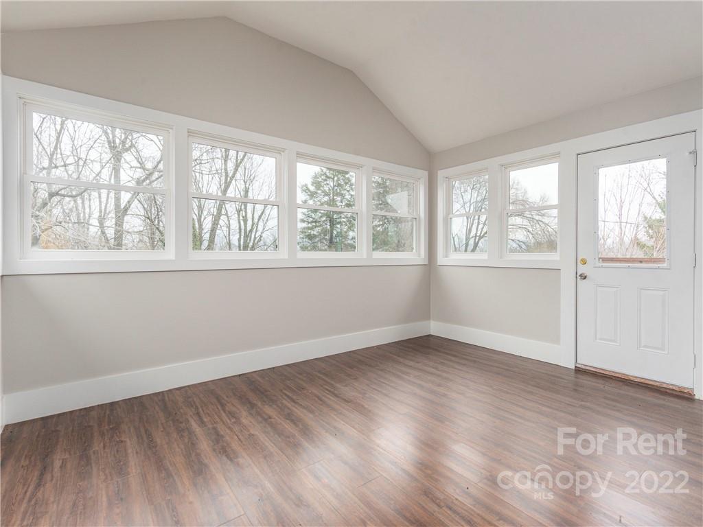 841 Haywood Road Asheville, NC 28806 - Photo 18 of 31 an empty room with wooden floor and windows