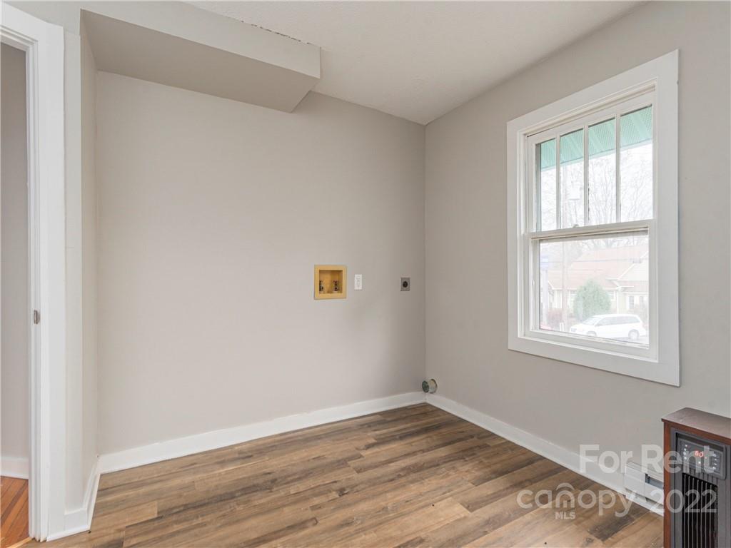 841 Haywood Road Asheville, NC 28806 - Photo 20 of 31 an empty room with wooden floor and windows