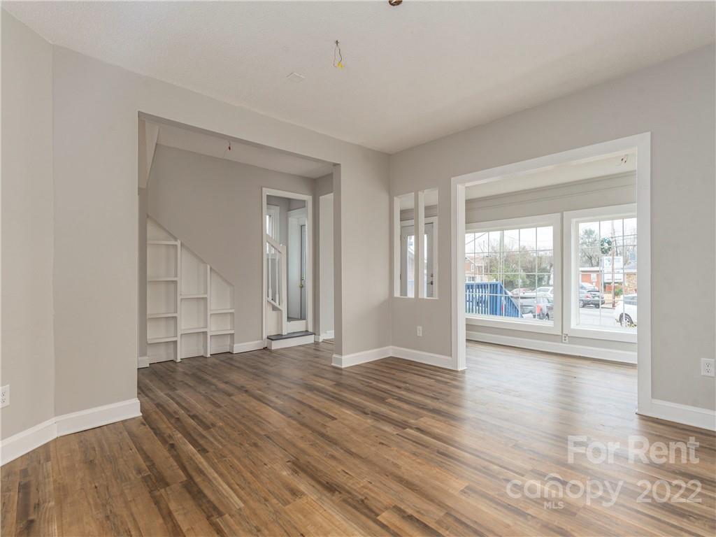 841 Haywood Road Asheville, NC 28806 - Photo 2 of 31 a view of empty room with wooden floor and fan