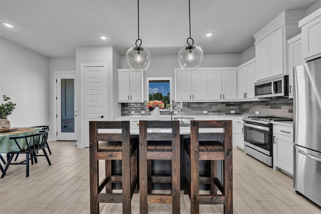 2004 Willy Dilly Road Springtown, TX 76082 - Photo 13 of 40 Modern kitchen featuring a central island with pendant lighting