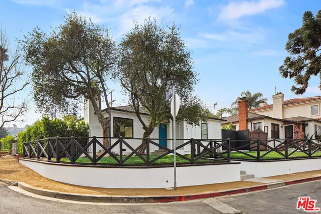 a view of a house with wooden fence
