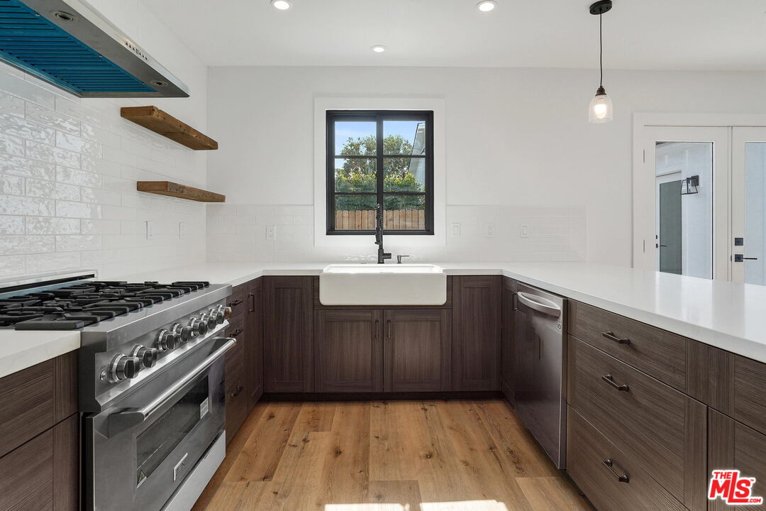 4130 Verdugo View Drive Los Angeles, CA 90065 - Photo 17 of 36 a kitchen with a sink stove and wooden cabinets