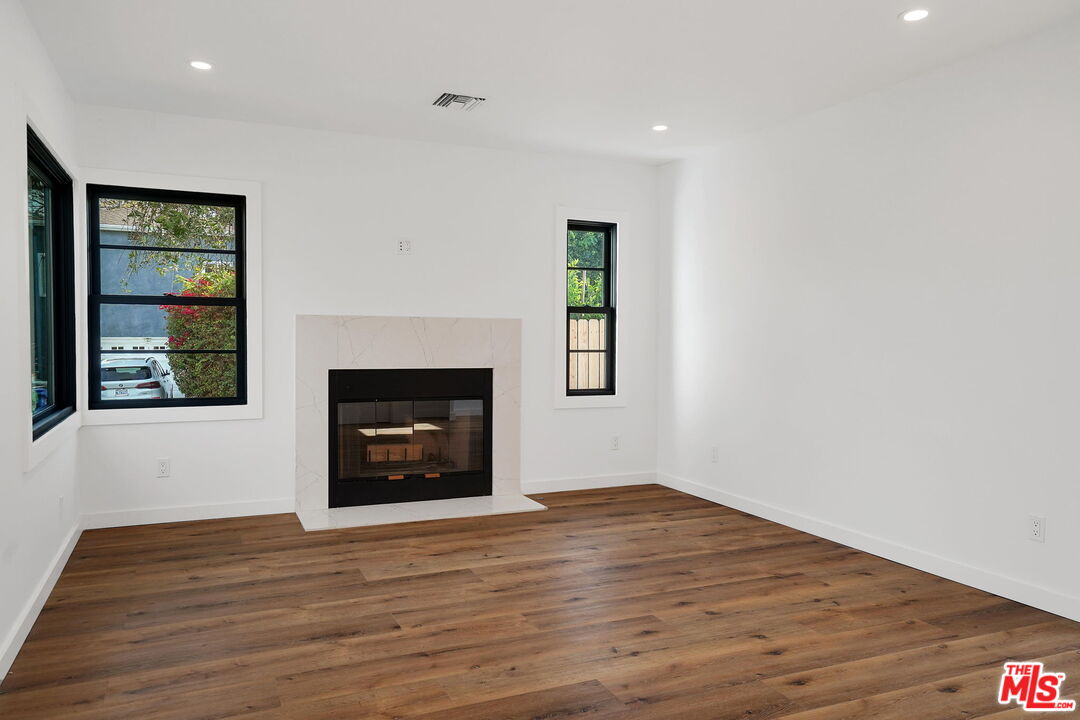 4130 Verdugo View Drive Los Angeles, CA 90065 - Photo 7 of 36 a view of an empty room with wooden floor fireplace and a window