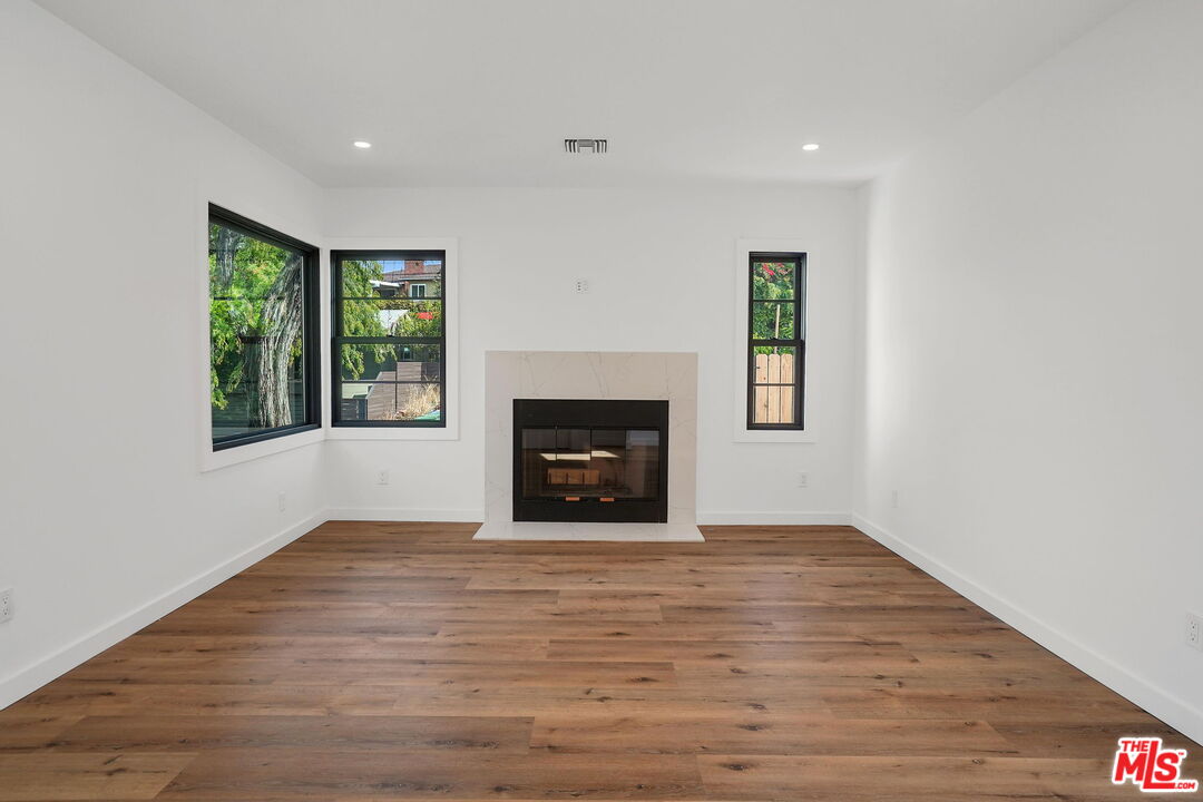 4130 Verdugo View Drive Los Angeles, CA 90065 - Photo 8 of 36 a view of empty room with wooden floor and fireplace