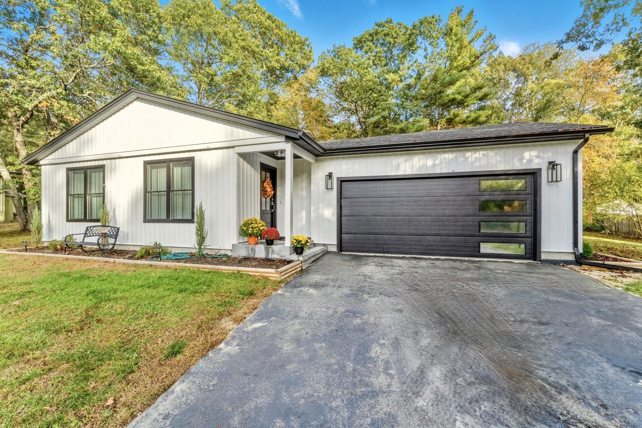 a front view of house with yard and outdoor seating