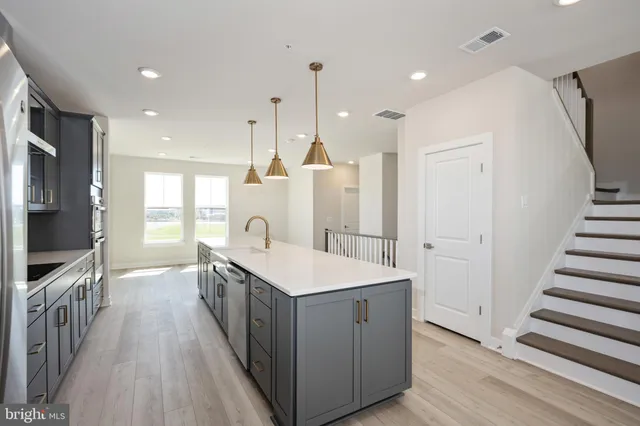 a kitchen with sink stove and refrigerator