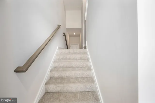 a view of staircase with white walls