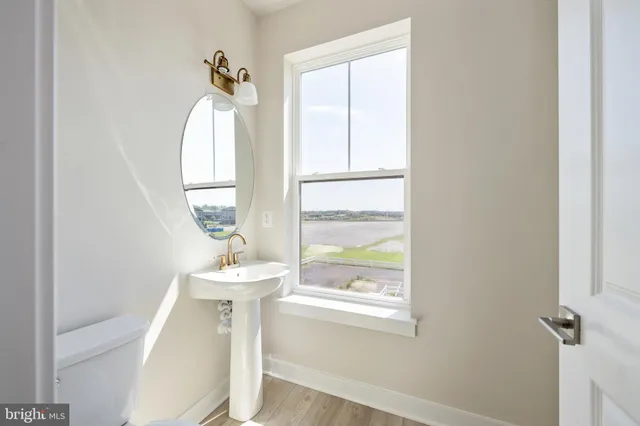 a bathroom with a sink a mirror and a window