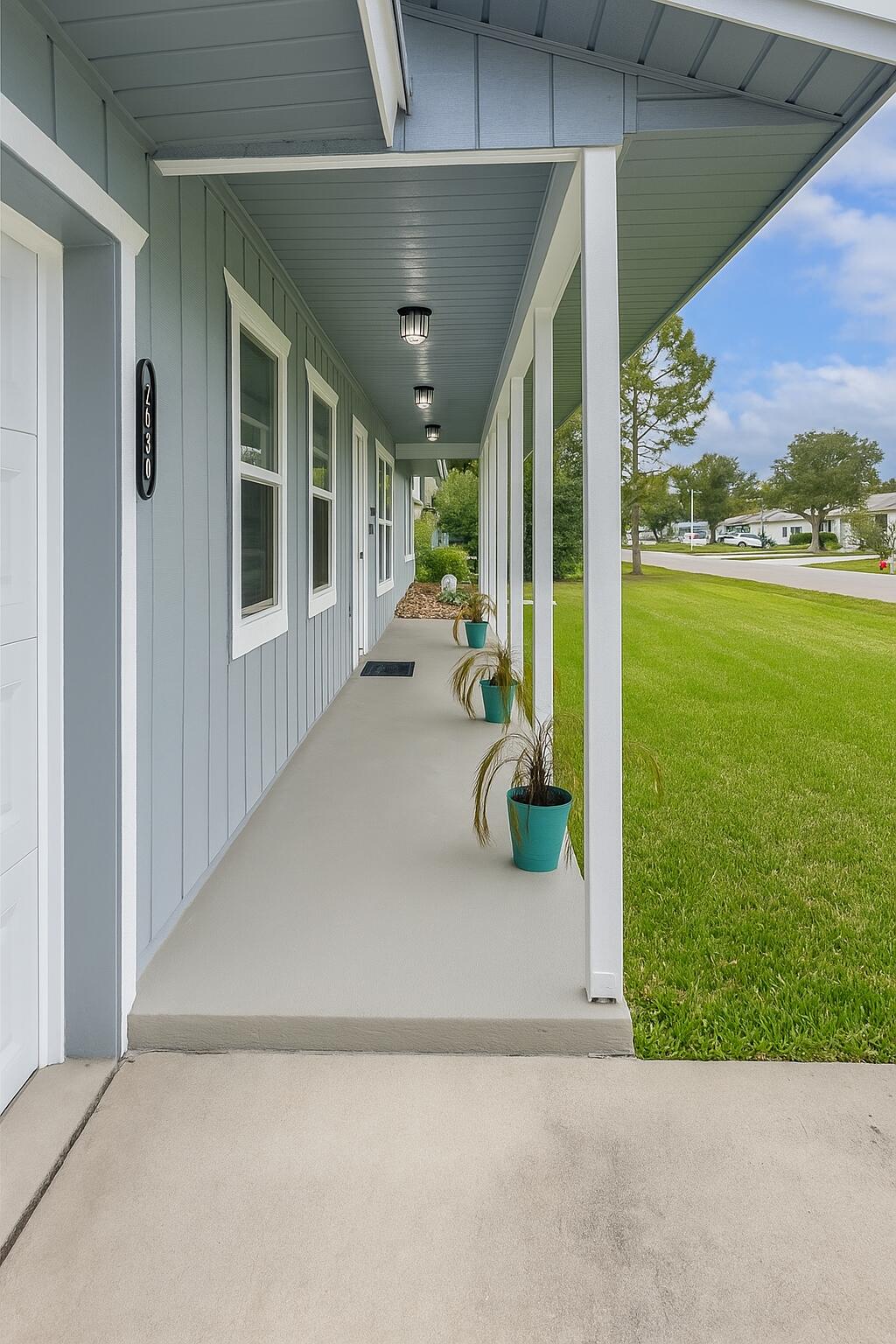 1892 Southwest Biltmore Street Port St. Lucie, FL 34984 - Photo 8 of 11 a view of a porch with furniture and garden view