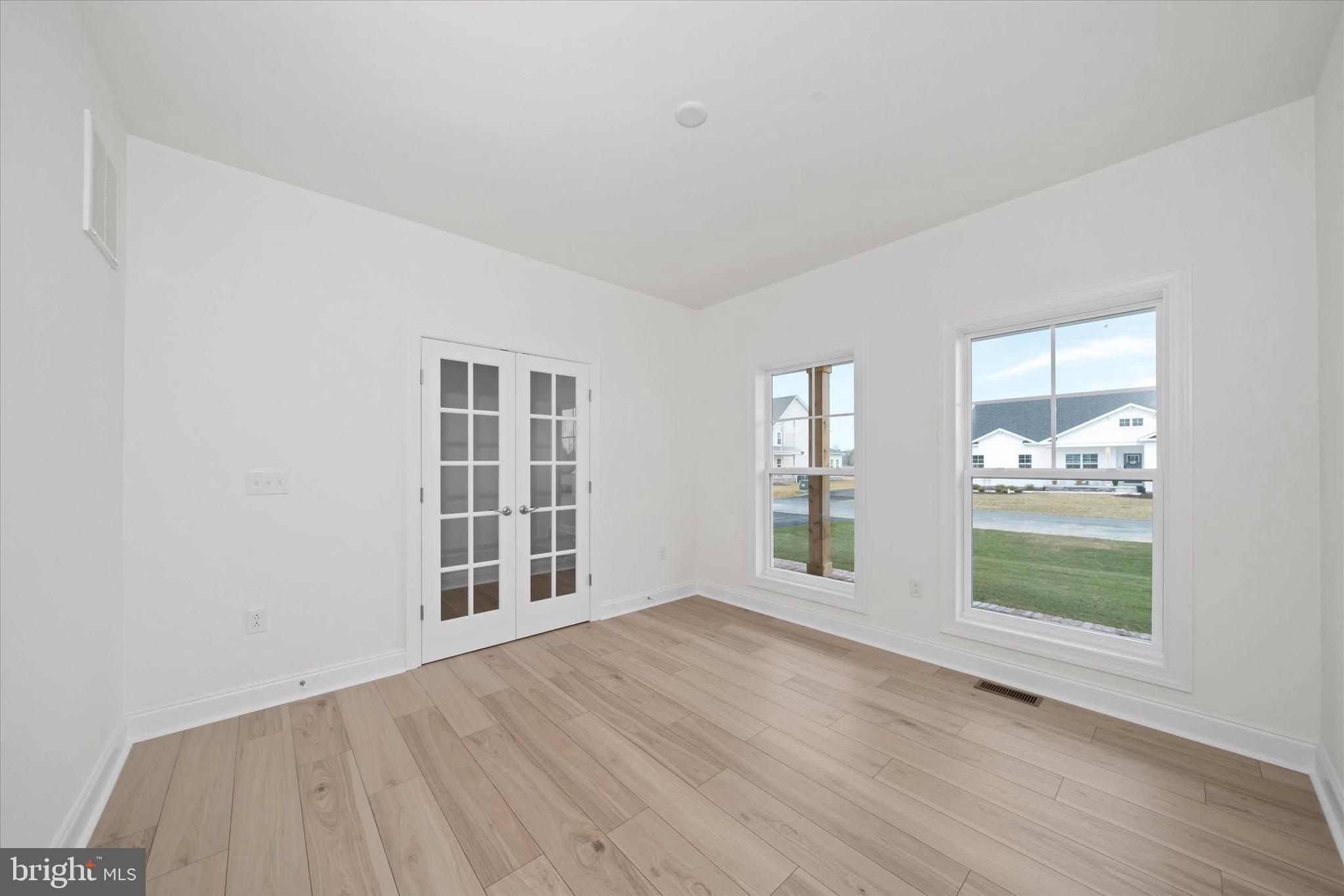 25246 Bethesda Road Georgetown, DE 19947 - Photo 19 of 41 an empty room with wooden floor and windows