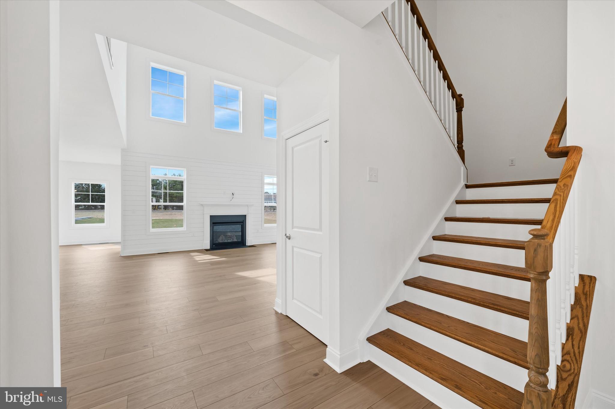 25246 Bethesda Road Georgetown, DE 19947 - Photo 4 of 41 a view of a livingroom with wooden floor and stairs