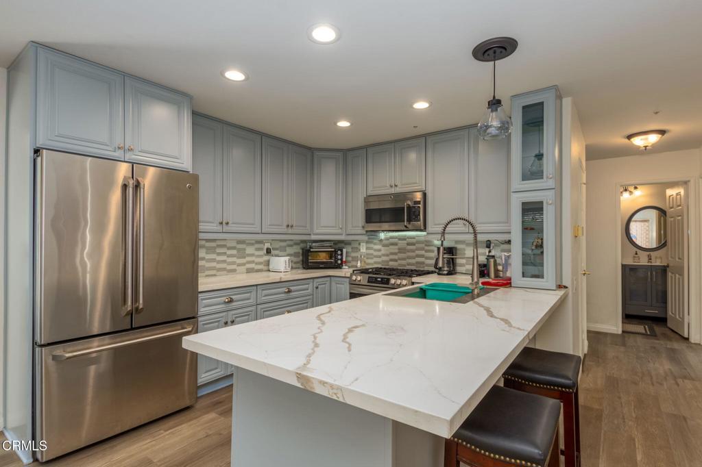 623 Novato Drive Oxnard, CA 93035 - Photo 6 of 22 a kitchen with stainless steel appliances a refrigerator sink and stove