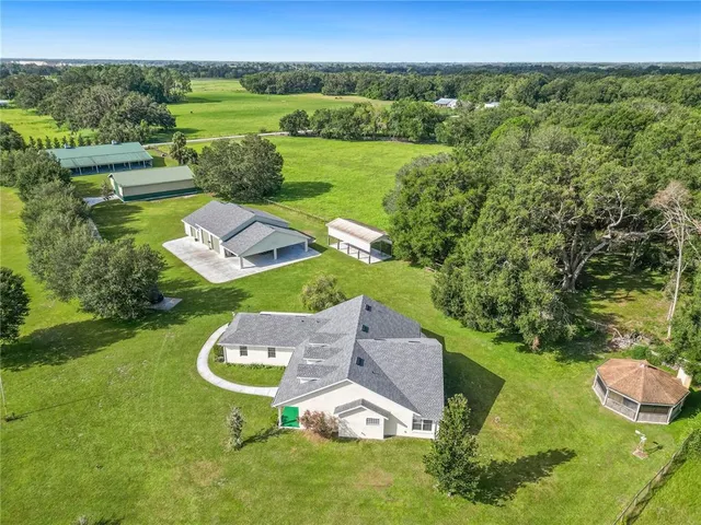 an aerial view of a house with garden space and outdoor seating