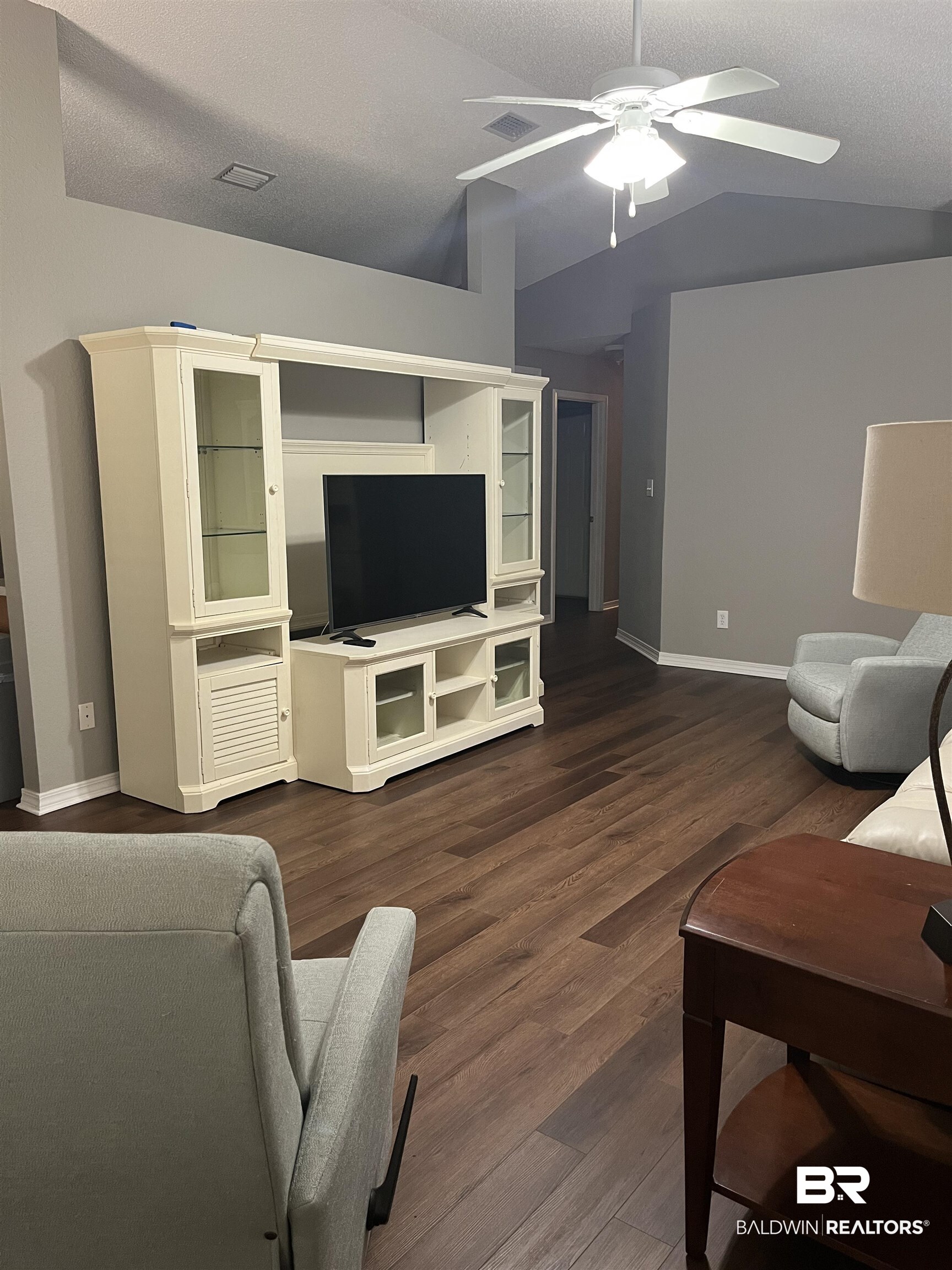 309 Cluster Street Foley, AL 36535 - Photo 10 of 38 Living area featuring wood-finish flooring, vaulted ceilings, and a ceiling fan with integrated lighting
