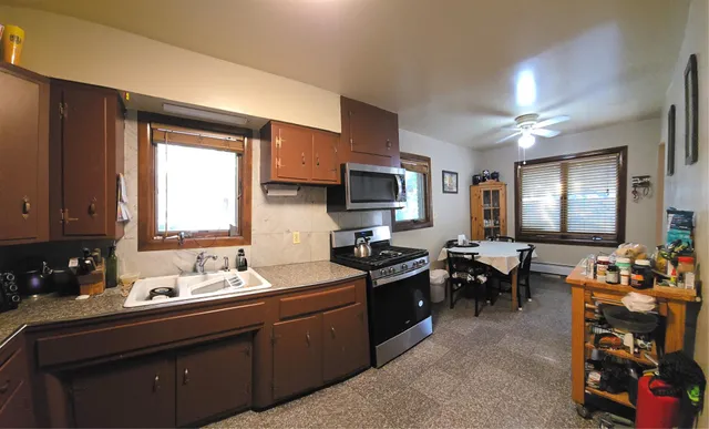 a kitchen with sink stove and cabinets