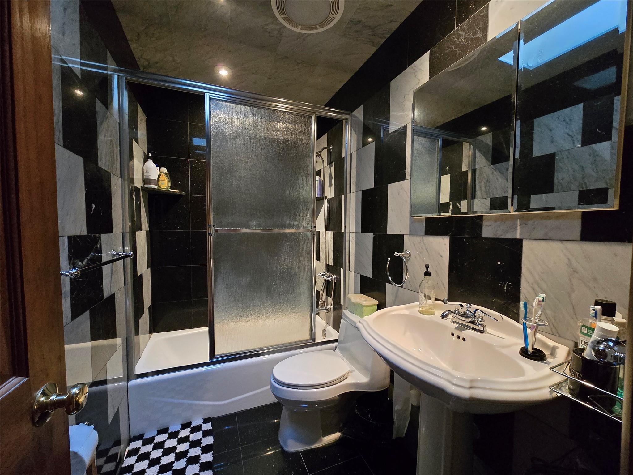 204-19 46th Road Queens, NY 11361 - Photo 14 of 23 a bathroom with a sink toilet and shower