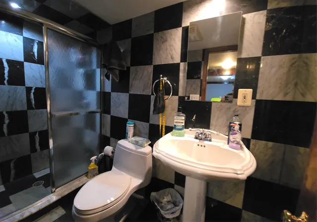 a white toilet sitting next to a bathroom sink