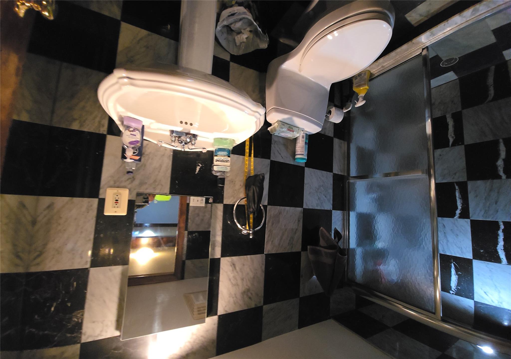 204-19 46th Road Queens, NY 11361 - Photo 17 of 23 a white toilet sitting next to a bathroom sink