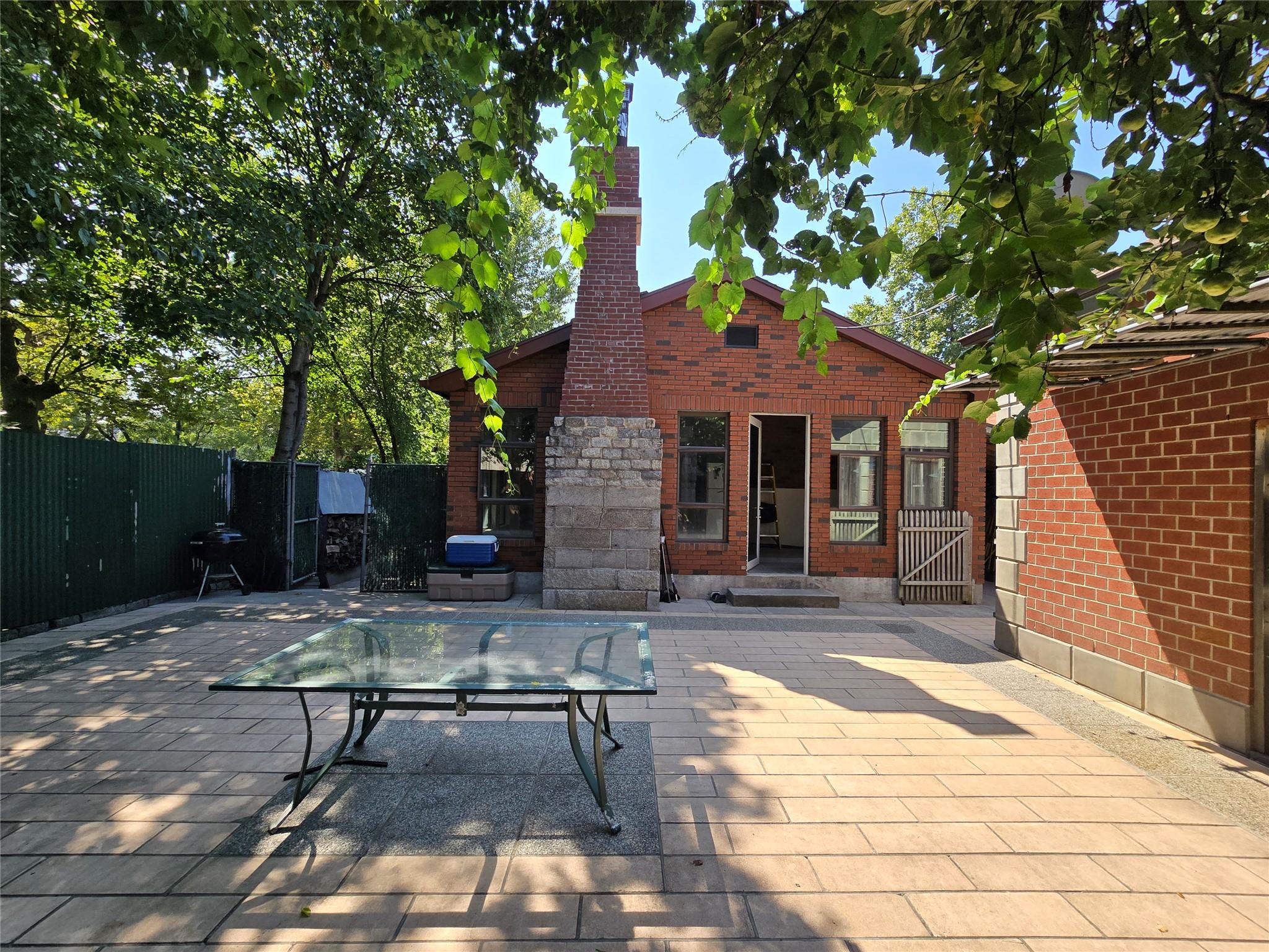 204-19 46th Road Queens, NY 11361 - Photo 21 of 23 a view of a patio with table and chairs and wooden fence