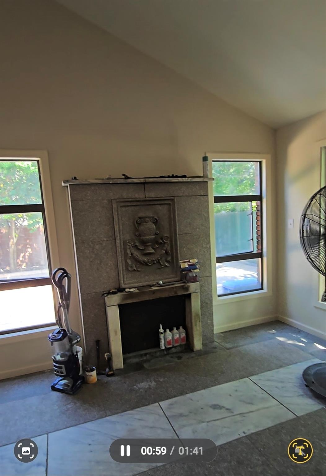 204-19 46th Road Queens, NY 11361 - Photo 23 of 23 a living room with a fireplace and windows