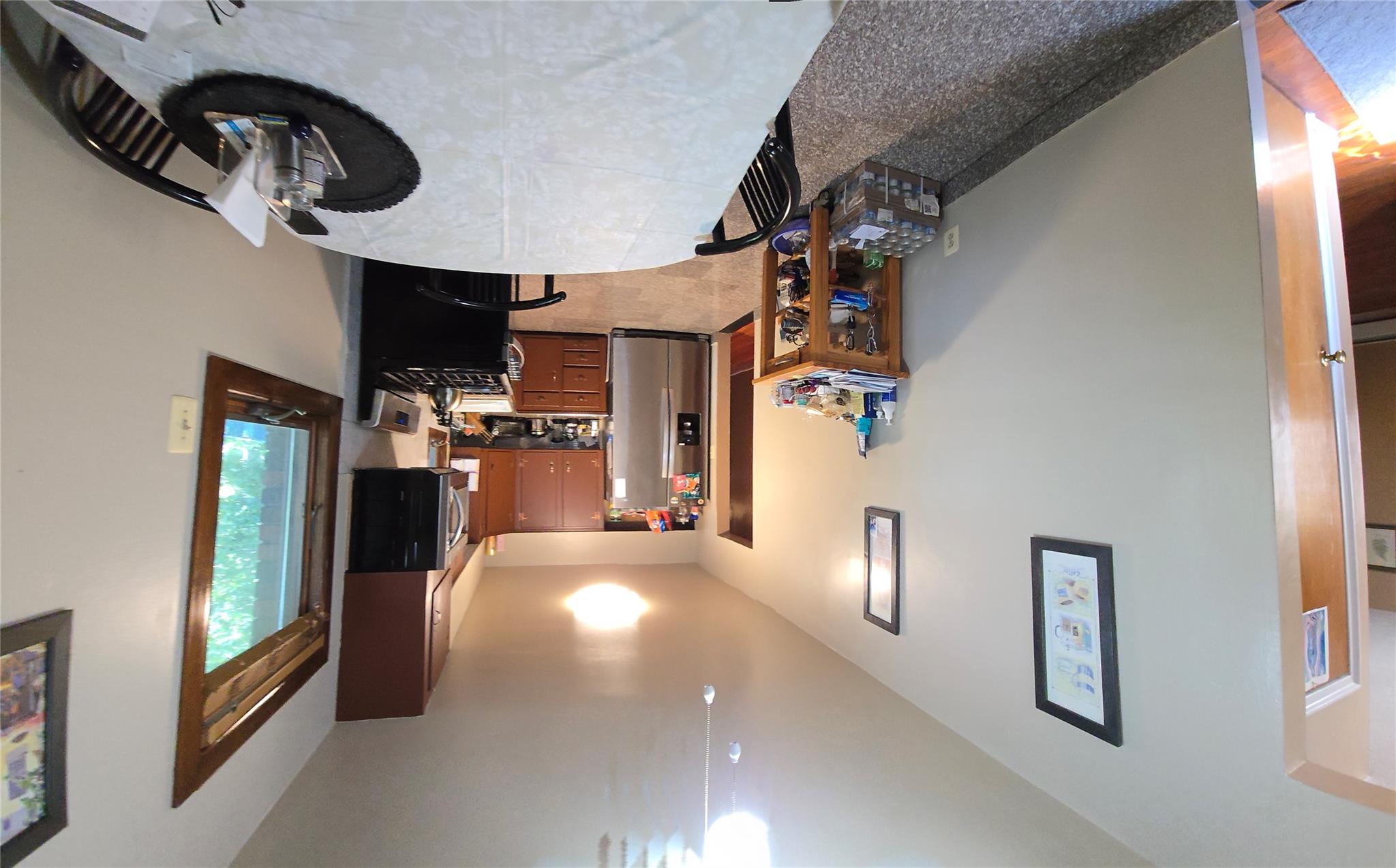 204-19 46th Road Queens, NY 11361 - Photo 7 of 23 a room with furniture a flat screen tv and a window