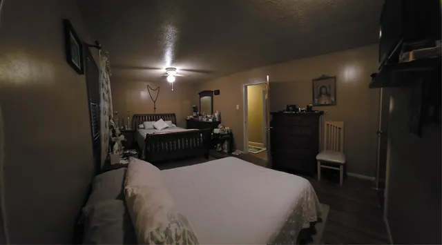 a bed room with a bed and a chair