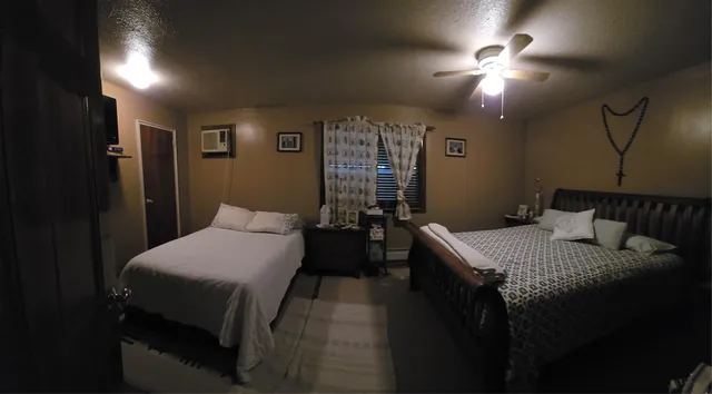 a bedroom with a bed and ceiling fan