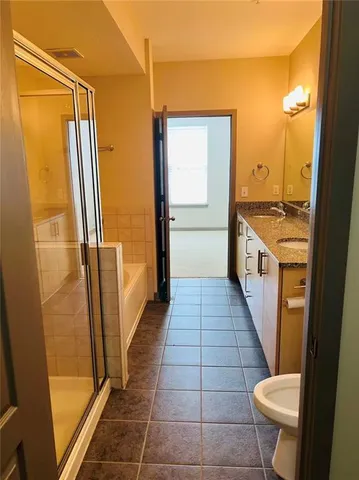 a bathroom with a sink a toilet and a shower