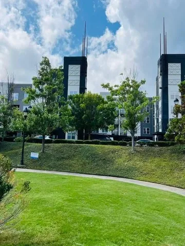 a view of a garden with a building in the background