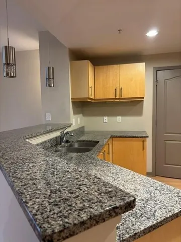 a kitchen with a sink a stove and cabinets