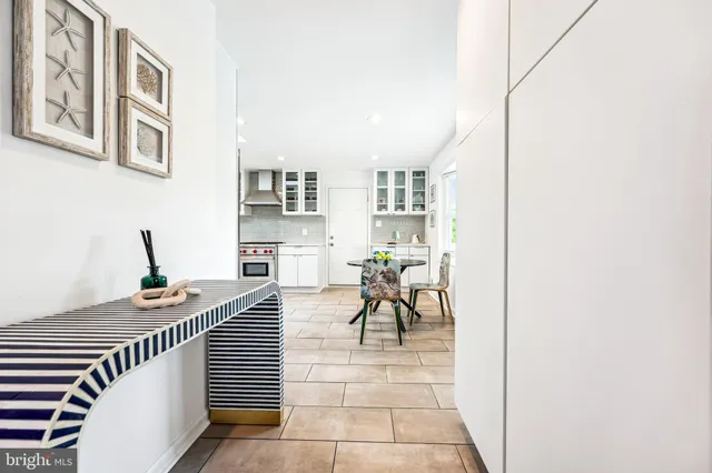 a dining room with furniture and a potted plant