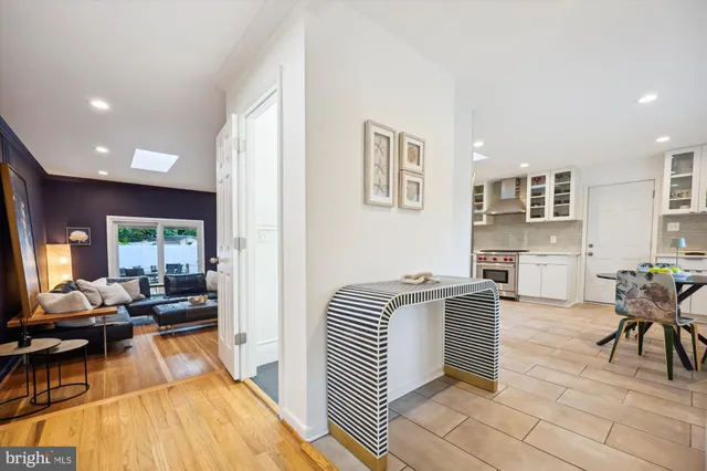 a living room with fireplace furniture and a rug
