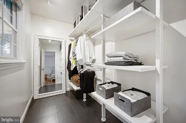 a spacious bedroom with a bed and a table in it