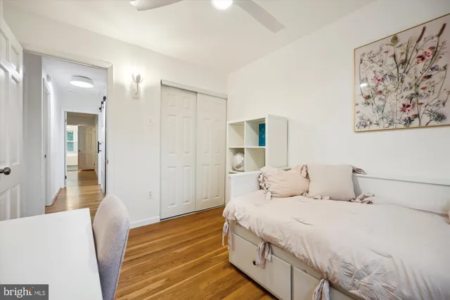 a bedroom with a bed and a painting on the wall
