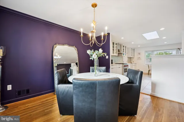 a dining room with furniture and chandelier