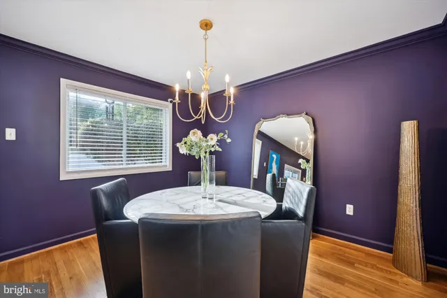 a dining room with furniture a chandelier and window