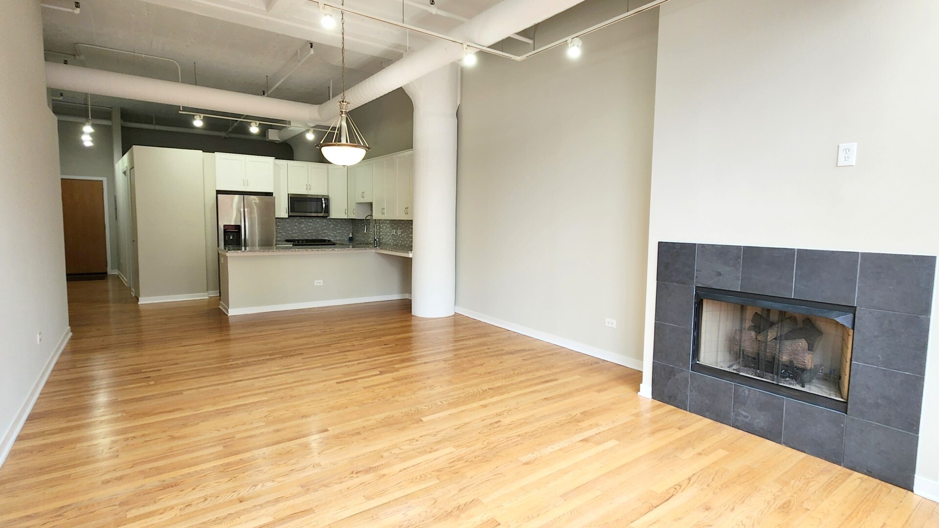 333 West Hubbard Street, Unit 607 Chicago, IL 60654 - Photo 2 of 15 a view of a hallway with wooden floor and a kitchen