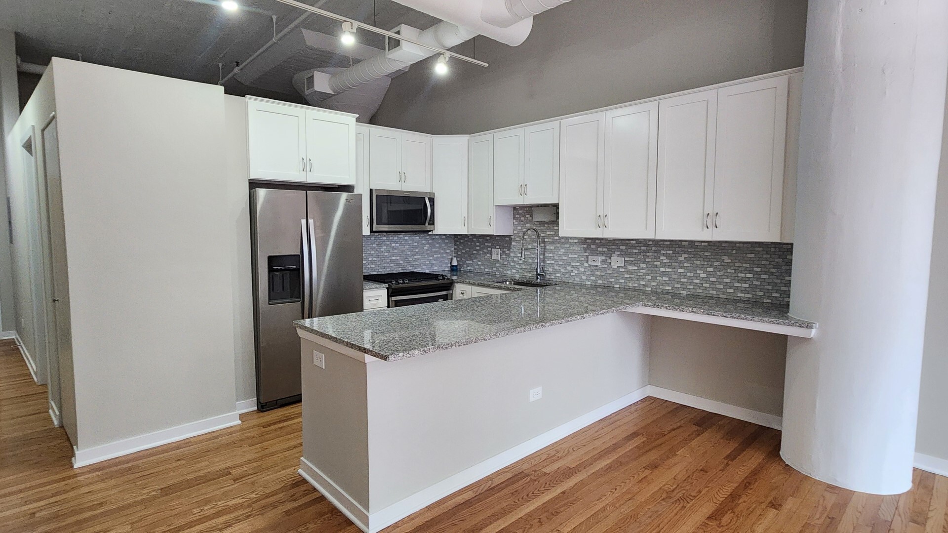 333 West Hubbard Street, Unit 607 Chicago, IL 60654 - Photo 3 of 15 a kitchen with stainless steel appliances a refrigerator sink and microwave