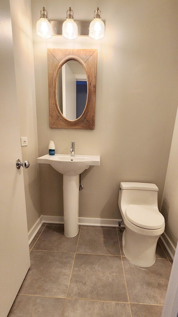 333 West Hubbard Street, Unit 607 Chicago, IL 60654 - Photo 4 of 15 a bathroom with a sink toilet and mirror