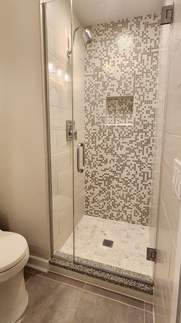 333 West Hubbard Street, Unit 607 Chicago, IL 60654 - Photo 5 of 15 a bathroom with a shower and a toilet