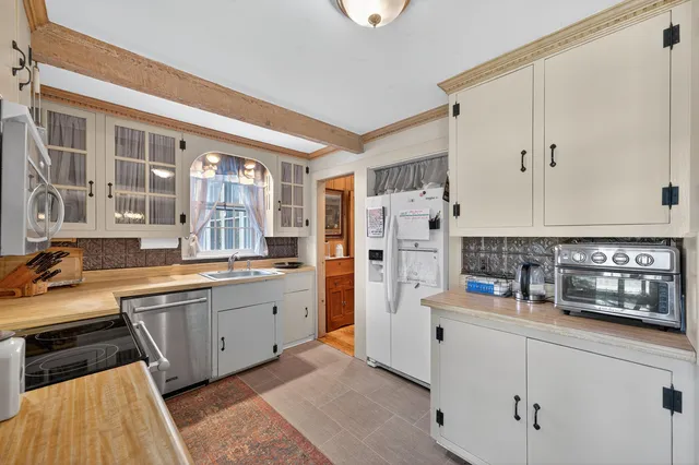 a kitchen with stainless steel appliances a refrigerator and cabinets