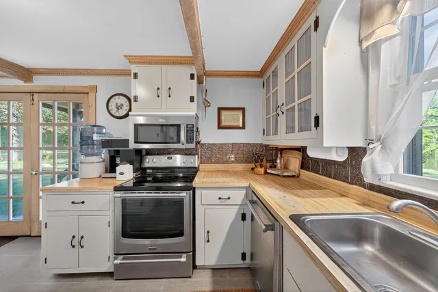 a kitchen with a stove a sink and a refrigerator