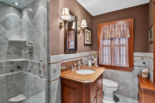 a bathroom with a sink toilet and shower