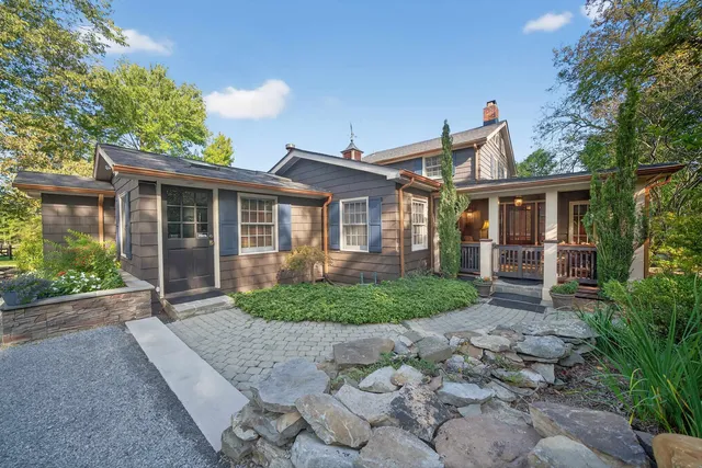 a front view of a house with garden