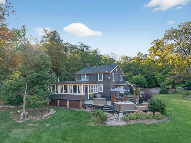 a view of a house with a backyard porch and sitting area