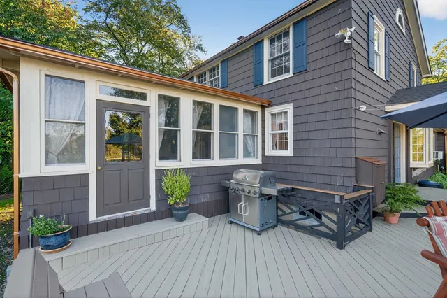 a view of a house with a bench and wooden floor